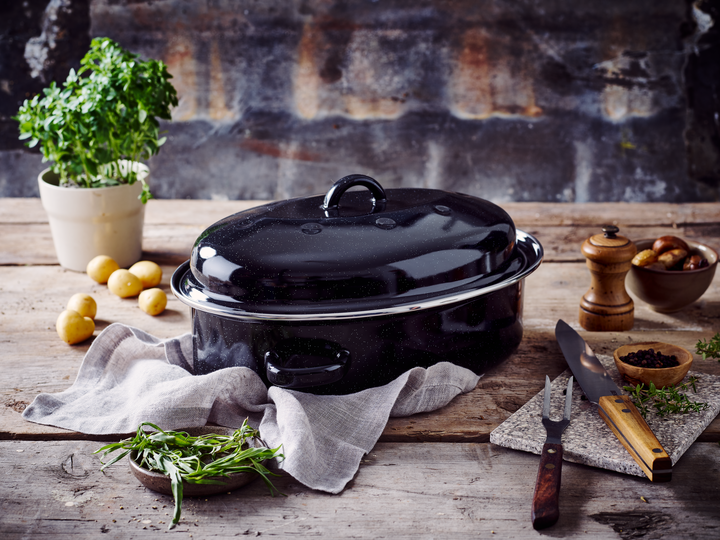 Enamel oven tray with dome lid in oven