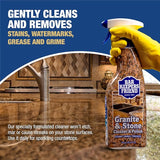 Bar Keepers Friend Granite & Stone Cleaner with a gloved hand holding the bottle, set against a kitchen background.