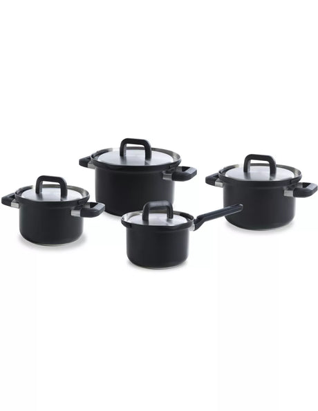 Set of black cookware pots with lids on a white background